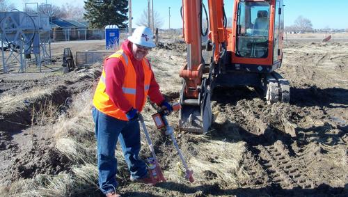 Owner working hard in commercial field to locate power lines.